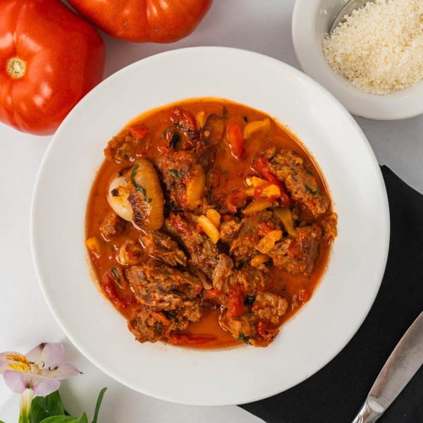 Hearty Italian stew with meat, vegetables, and a rich tomato sauce, served with parmesan cheese.